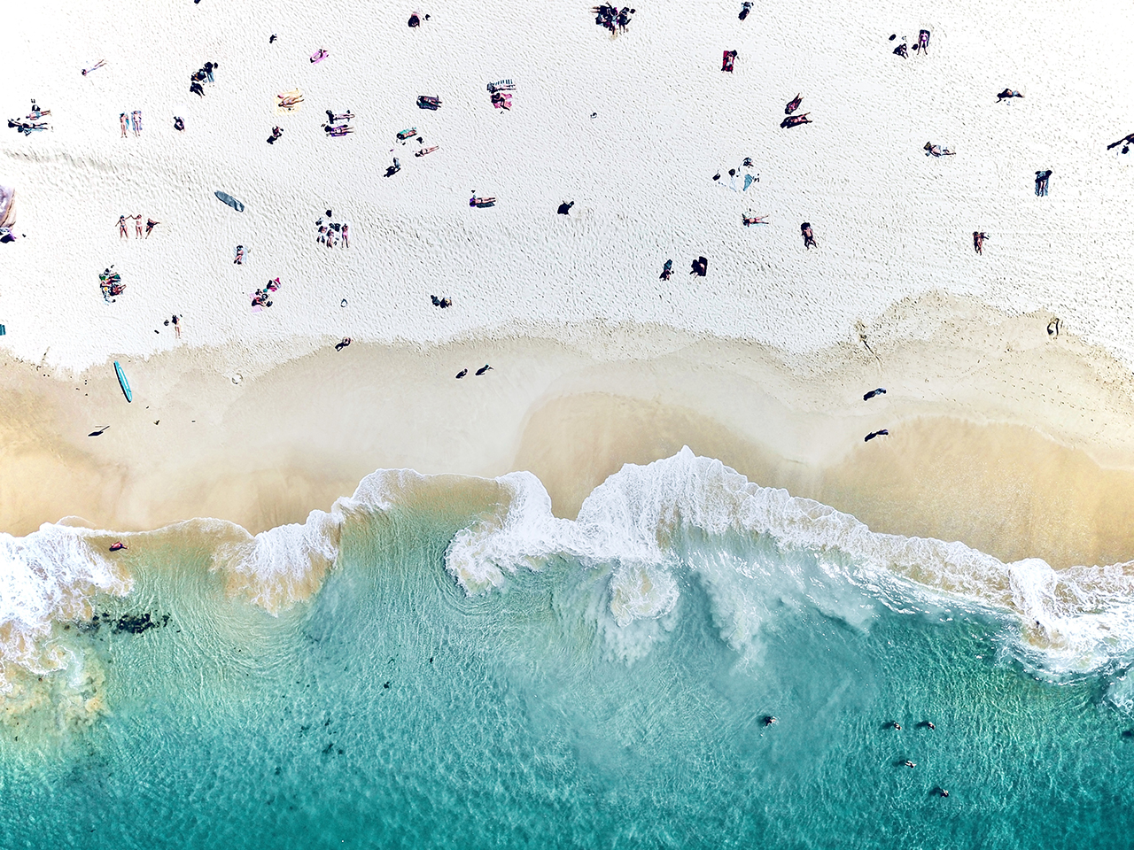Ocean waves meeting a beach, seen from above
